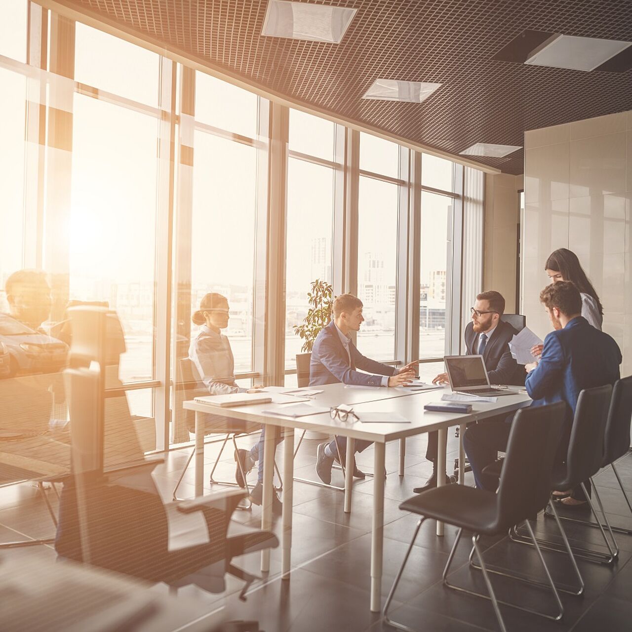 Besprechungsraum mit Beschäftigten im Gespräch sitzend an einem Besprechungstisch